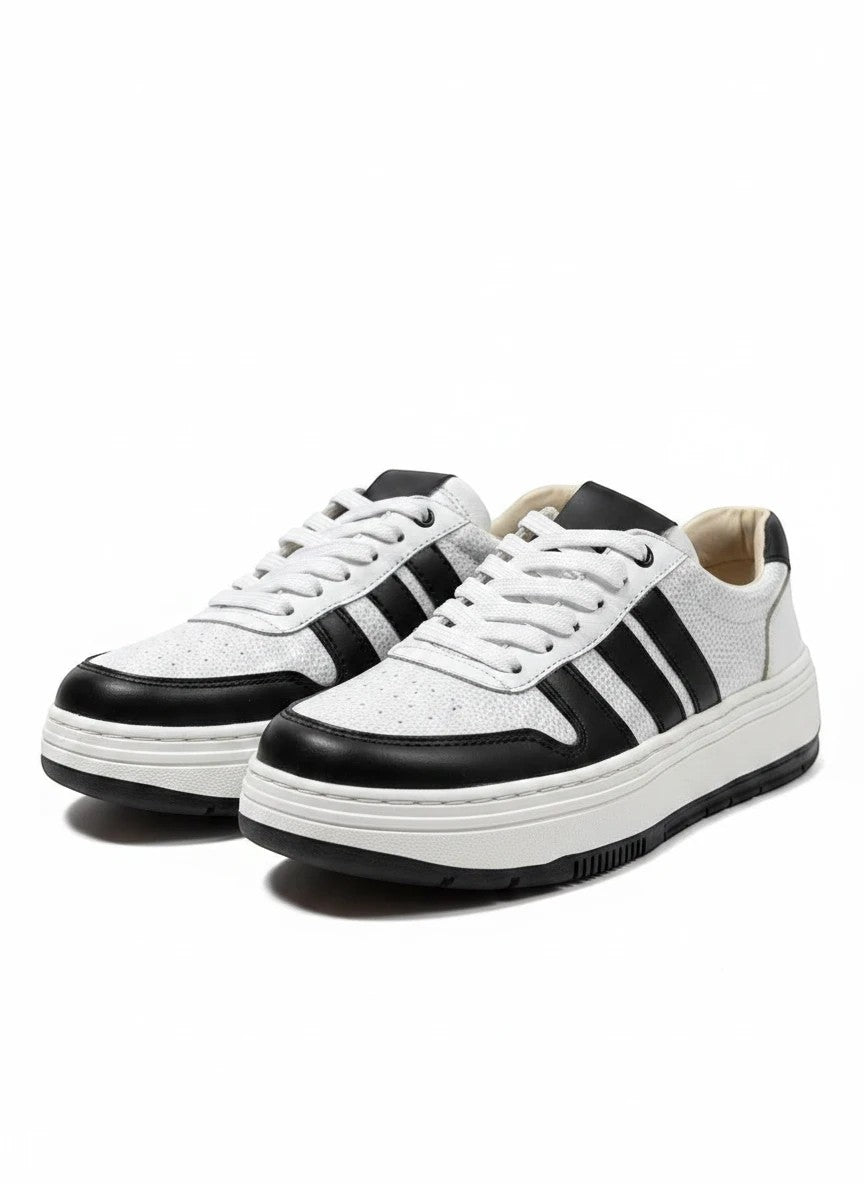 Zapatillas urbanas gavani shoes co de cuero blanco y negro con textura granulada y suela de plataforma.