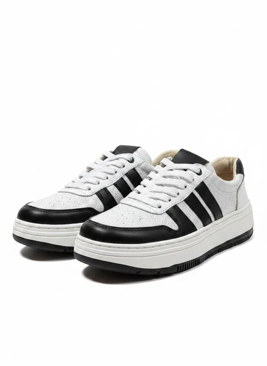 Zapatillas urbanas gavani shoes co de cuero blanco y negro con textura granulada y suela de plataforma.