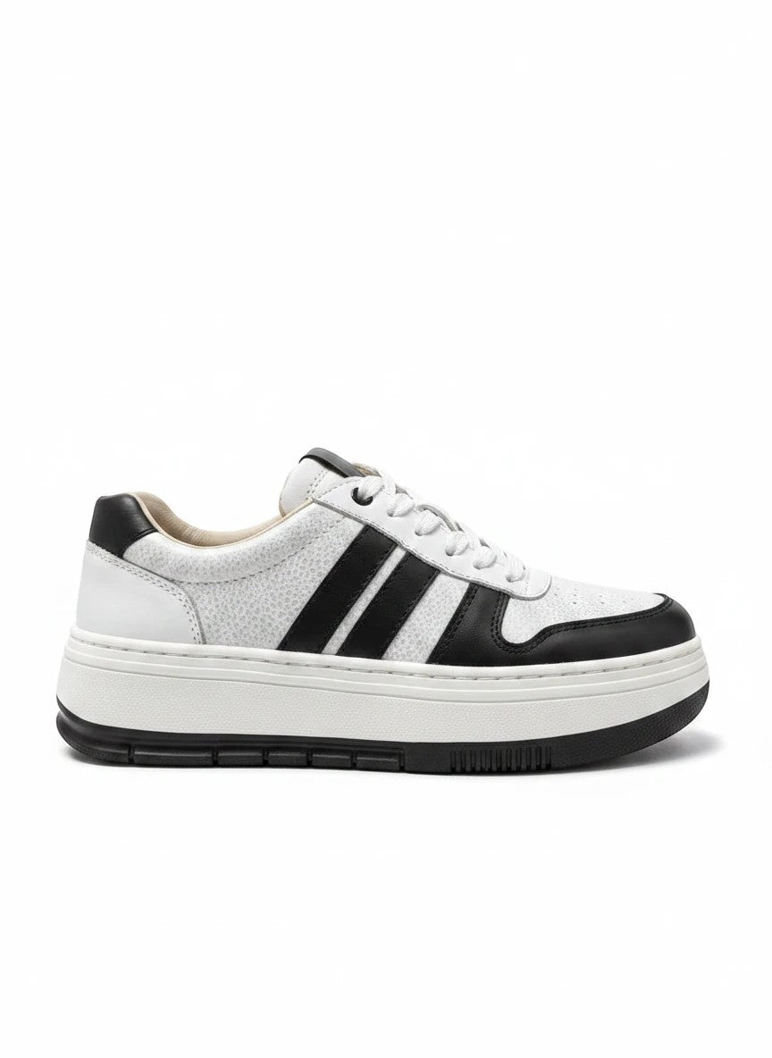 Zapatillas urbanas gavani shoes co de cuero blanco y negro con textura granulada y suela de plataforma robusta.